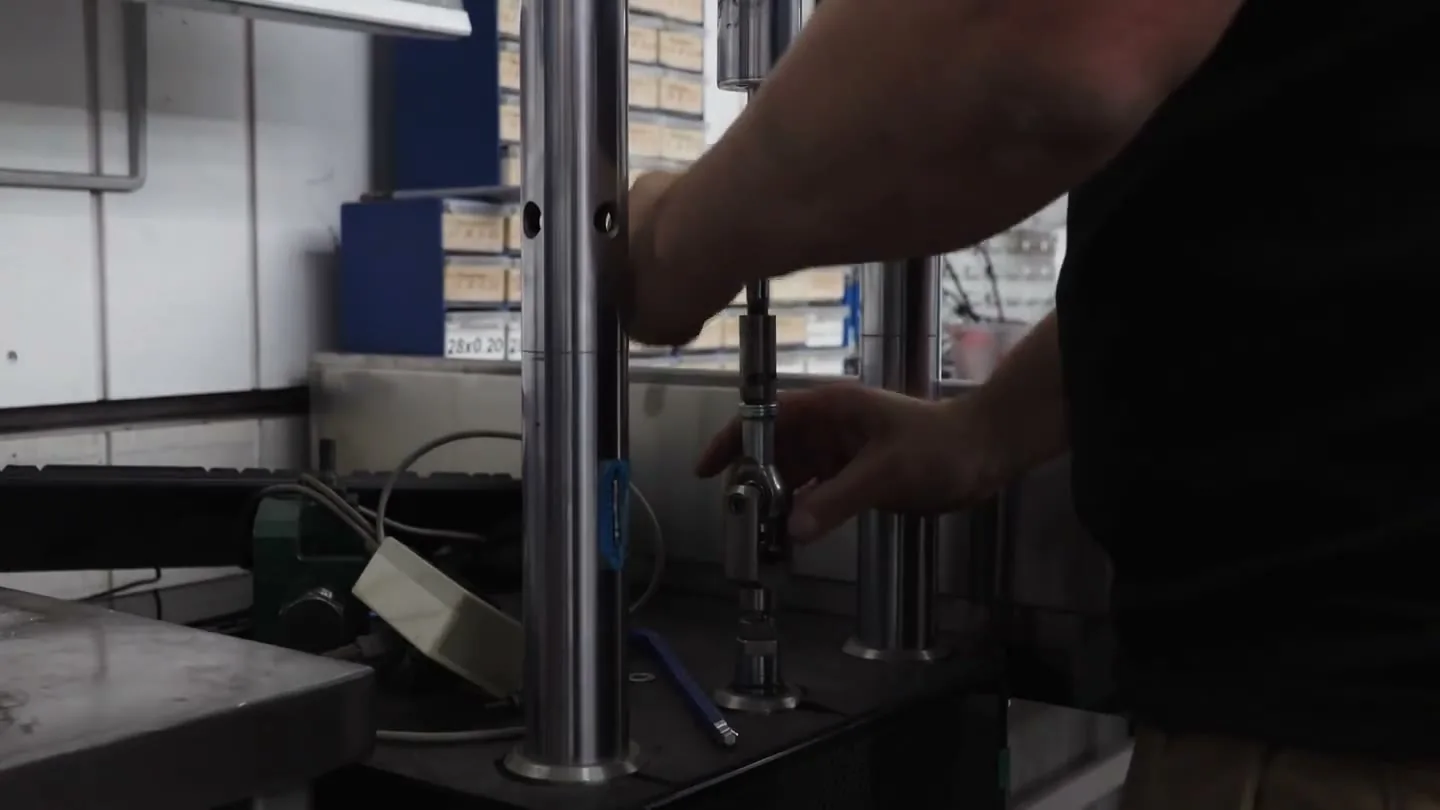 A Shockworks damper mounted in the workshop dyno rig during shock testing