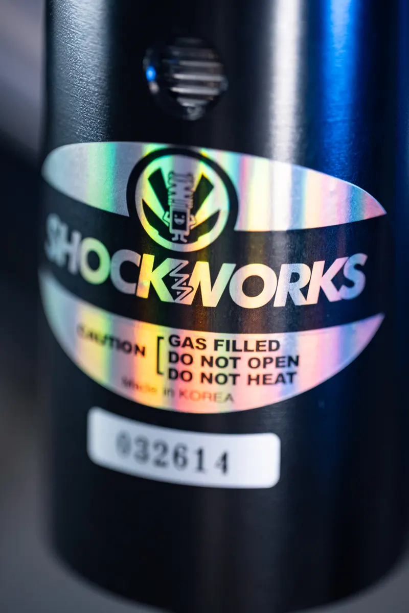 The holographic Shockworks label and serial number on a black damper body
