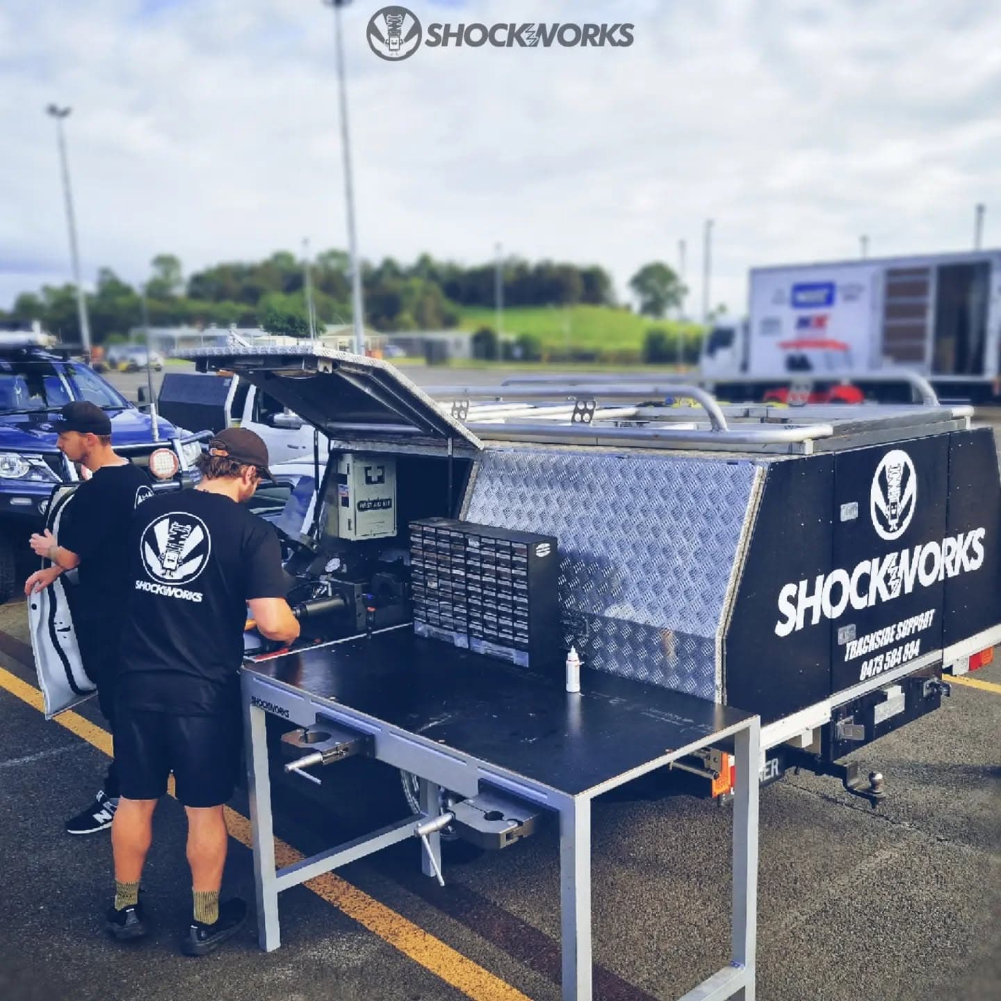 The Shockworks trackside support ute with its gullwing canopy open and workbench folded out at a racetrack