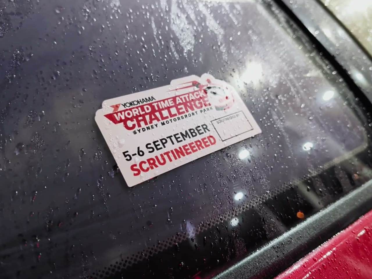 Last year's WTAC scrutineering sticker on the S13's rain-beaded quarter glass